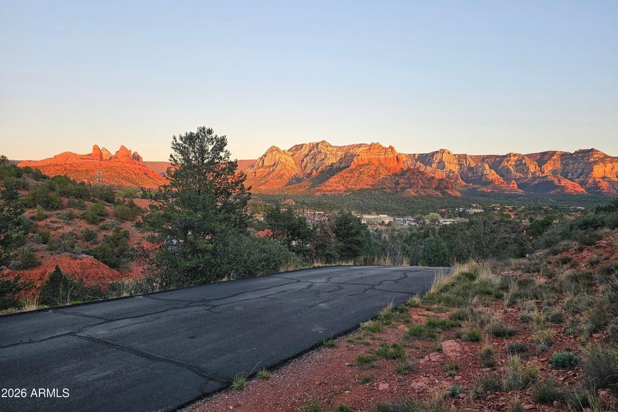 This elevated lot in West Sedona's coveted Rolling Hills Estates is your blank canvas for a custom home with epic views most buyers spend years chasing and never find. The North-facing homesite captures both sunrise and sunset as they paint the red rocks, with unblockable, panoramic vistas in every direction.

To the east, enjoy iconic views of Snoopy and Cleopatra (Camel). Look north to Wilson, Shiprock, and Steamboat. To the west, soak in Thunder Mountain, Coffee Pot, Sugarloaf, and Chimney Rock. Very few lots in town offer this kind of sweeping, 180-degree red rock panorama.

Located in desirable West Sedona, Rolling Hills Estates offers an established neighborhood location with ultra-convenient access to everything: just minutes to SR 179, a straight shot up the canyon to Flagstaff, and close to all West Sedona amenities. Dining, shopping, galleries, and everyday services are all nearby, with multiple world-class hiking and biking trailheads within easy reach.

Rolling Hills Estates is a relaxed, established neighborhood in the heart of West Sedona with low HOA dues of just $300/year. You get pride-of-ownership surroundings without the heavy-handed rules or big fees.

If you're tired of compromising on floorplans, windows, or orientation - 256 Barcelona is your solution! Design exactly what you want and frame every room around jaw-dropping views. This building site offers easy access to everything, and the freedom to build the home you can't find on the market! Note: Seller is an Arizona Licensed Realtor.
