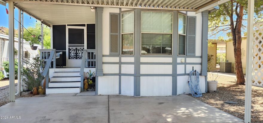 Charming single-wide with a well-designed split floor plan. The primary bedroom features a bay window and vaulted ceilings. Enjoy added living space with an enclosed screened deck and a covered patio featuring a wet bar--perfect for entertaining. A custom ¼ bath adds convenience. Surrounded by mature landscaping for a peaceful setting. Updates include a newer refrigerator, dishwasher, blinds, wood flooring, roof, HVAC, PEX plumbing, water softener, and screen room addition. Kitchen and baths have been updated. Exterior features include drip irrigation, raised garden beds, and a self-filling fountain--offering comfort, function, and charm.