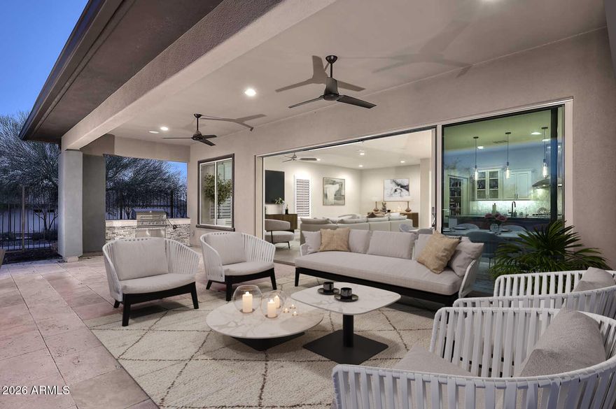 Upon entering this single-level home, located in the upscale Trilogy community, you are immediately drawn to its exceptional curb appeal, highlighted by elegant stonework across the front of the property and a welcoming entryway. This thoughtfully designed residence offers two bedrooms plus a den, providing flexible space for work, hobbies, or guests. Inside, the open-concept kitchen, living, and dining area immediately captures your attention with stunning mountain views. Expansive sliding glass doors create a seamless indoor-outdoor connection, opening to a true resort-style backyard ideal for entertaining or relaxing.  The kitchen is beautifully appointed with granite countertops, stainless steel appliances, and a designer backsplash that cohesively ties the space together. Every detail reflects professional design and quality finishes throughout the home. The spacious primary bedroom offers a peaceful retreat, complemented by a gorgeous primary bath featuring a walk-in shower and upscale finishes. 
Step outside to the covered back patio with elegant stone flooring, where breathtaking mountain views create the perfect backdrop for Arizona living. The outdoor space is complete with a built-in barbecue pit and a built-in fire pit, offering an ideal setting for year-round gatherings. Additionally, the garage features epoxy-coated floors and custom built-in cabinetry, providing ample storage and a clean, finished space for both vehicles and organization. Owned solar panels provide exceptional energy efficiency and long-term cost savings, while the expansive extended garage offers generous space to comfortably accommodate up to three vehicles.
