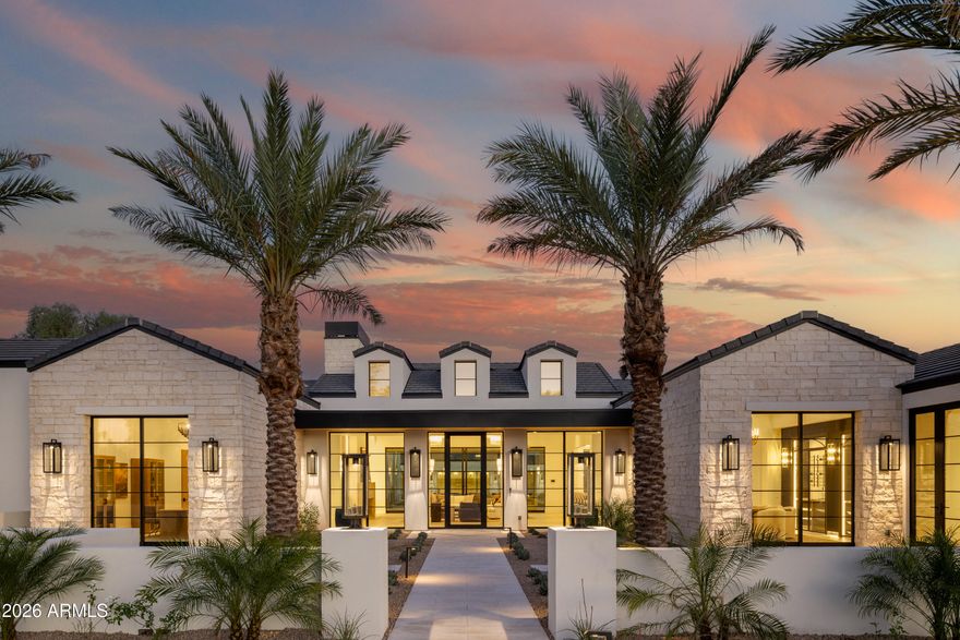Set on a quiet cul-de-sac in the heart of Paradise Valley, this custom estate offers a true split floor plan with refined architecture and thoughtfully curated interiors by London Pierce Design. The main living space is defined by vaulted gable detailing with dormer light, rift white oak cabinets, a custom fireplace, and a full western door system that opens seamlessly to the backyard. The chef's kitchen features barrel-vaulted ceilings with custom lighting, dual stone islands, bespoke cabinetry, Wolf + SubZero appliances, and an exceptional oversized scullery. Arched hallways finished in Roman clay add depth and continuity throughout. Entertaining spaces include a formal dining room with a custom wine wall, plus a morning room that opens directly to the outdoor kitchen. Additional interior amenities include a dedicated office, a glass-lined workout room, and a large game room with direct access to the pool and outdoor living areas.

The private primary wing features a spa-quality bath with dual vanities, a soaking tub, and an oversized walk-in shower, along with separate his-and-hers closets, dual water closets, and a secondary laundry. On the opposite wing, secondary en-suite bedrooms are thoughtfully positioned for privacy. Outdoor living is anchored by a covered patio, large pool and spa, and a private pickleball court. Lastly, a detached two bedroom, two bathroom guest house with its own living area and kitchenette adds flexibility for guests or extended stays or multi-generational living.
