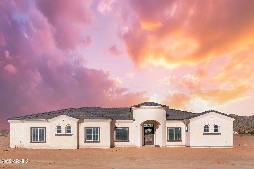 Stunning new construction!   Nearly complete custom home with 10 ft celings, jaw-dropping living areas.   Home has an iron door entry, oversized kitchen with quartz countertops, a pot filler, a gas stove, and double oven. Comes with over an acre of land and with a 400 AMP electric service and is easily expandible to add a casita with county approval.  Home has a 3 car garage, with a gigantic covered patio. Home is pre-wired for surround sound in the Family Room, master room, and master bath.
Master bedroom is a heavenly retreat with spacious tub and a separate, tiled, walk-in, super-shower. 

Paved road installation scheduled for end of 2026