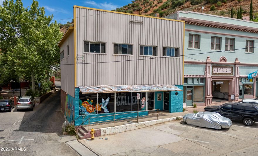 Incredible opportunity to own an iconic building in the heart of Old Bisbee. Ideally positioned in a prime, high visibility location directly across from the largest public parking area. Situated to capture the steady flow of visitors that make Bisbee a top rated destination. The ground level commercial space, formerly an art gallery, features expansive display windows that provide excellent exposure for any business. Upstairs, a charming 2 bed 1 bath apartment is currently tenant occupied, providing immediate income. An additional upstairs space offers the opportunity to create a 2nd apartment, ideal for an owner occupant or additional tenant. All of this is just a short walk from popular restaurants, hotels, bars, and museums, making it a truly exceptional live/work/tenant income space.