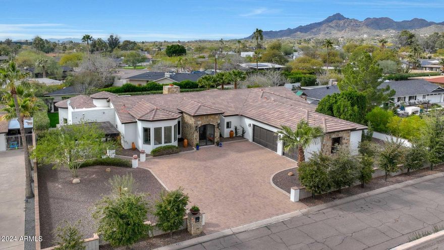 Perfectly situated just a stone's throw away from the newly established Global Ambassador hotel, and mere minutes from Arcadia's vibrant center, this location offers unparalleled convenience. With numerous exquisite dining options, the Village racket club, and AJ's fine foods all within walking distance, every amenity is at your fingertips. Enjoy breathtaking vistas of Camelback Mountain from the front cabana, while bi-fold doors seamlessly connect you to a resort-style backyard featuring a sparkling new pool and lush greenery. Inside, the kitchen boasts custom wood cabinets, an expansive island, SubZero refrigerator, and a wine fridge. The finished basement adds to the allure with a wet bar, full bath, and pool table, culminating in the ultimate family retreat.