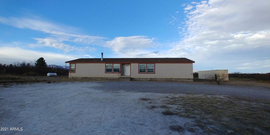This home has a great floor plan with a large living room with a fireplace and a family room. There are builtins in the family room too. There is a big kitchen with an island and tons of cabinetry. There is a breakfast bar off of the dining area as well. The floor plan is split. There is a lovely master suite with a walk in closet and huge bath room. Step out back to enjoy the beautiful view of the Huachuca Mountains from the covered patio. This home has an assumable VA loan.  at 171K. This is an AS IS sale.