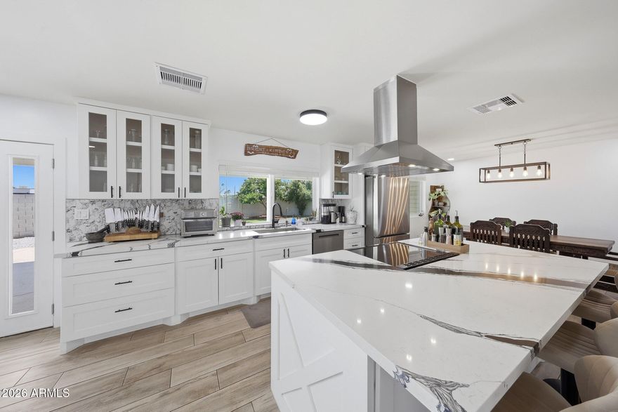 Completely renovated, this single-level 4-bedroom, 2-bath home sits on a premium 11,643sf cul-de-sac lot in the sought-after Bellair community. Offering over 2,000sf, the open great room floor plan is filled with natural light and features porcelain plank flooring, current finishes, and a wood-burning fireplace. The remodeled kitchen includes quartz countertops, marble backsplash, and newer stainless appliances. The spacious primary suite offers a walk-in closet with barn door and sleek en-suite bath, while three guest bedrooms share a beautiful secondary bath. Enjoy the deep covered patio and laundry room, oversized backyard ready for your dream oasis, 2-car garage, and RV gate. Walk to the Bellair Community Center and enjoy golf, pool, pickleball, clubhouse in a lush park setting.