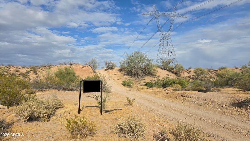 Scenic 5-acre parcel in Whispering Ranch with amazing desert views and incredible potential. Ideal for a custom home, manufactured home or long-term land investment. Seller financing available! Located on Dove Valley Rd which will someday be Dove Valley Parkway, adding to the area's future growth appeal. Floodplain in the SW corner of the property characterized by a gorgeous arroyo adding lots of charm and extra greenery with plenty of high & dry land to build on. Your driveway is already in place taking you from the front to the back of the property. Enjoy privacy, wide-open space, and a peaceful rural setting in one of Arizona's premier land communities. Come explore this exceptional opportunity today.