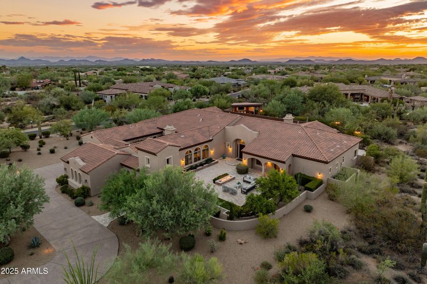 Where privacy, luxury & function collide...Your private resort awaits & shows like new!  Located on a quiet interior lot in the gated & highly desirable development of Saguaro Estates - it's the second largest semi-custom floor plan offered by Toll Brothers and sits on nearly 1.5 acres. A stunning kitchen w/ massive granite slab island housing 2 dishwashers, a 6-burner gas cooktop & 2 built-in ovens, & walk-in pantry. The master retreat is a true sanctuary w/ private sitting or exercise room, his/her bathrooms, and expansive closet. Designed for efficiency, the home features solar power, two tankless water heaters, & low-maintenance landscaping providing lower utility costs. The split floor plan flows seamlessly w/ no interior steps, media room w/ wet bar, wine fridge, beverage cooler, & ice maker, plus a sprawling four-car garage w/ new epoxy floors & built-in cabinetry. Host unforgettable backyard gatherings...perfect for 100 guests, w/ covered pool ramada, misting system, outdoor speakers, multiple fire features, & 2 BBQ areas. Stunning sunsets steal the show, making every evening magical. This one checks all the boxes...including the asking price!