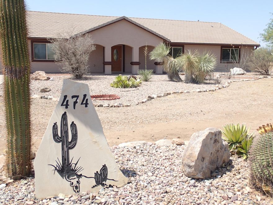 HUGE is not the right word for this Custom 2x6 constructed 3400sqft, 5Br and 3+bath with attached oversized 2+Car Garage built in 2005 on 8 fully fenced acres with private well.  Flat Tile Roof. Tasteful and Low Care landscaping with trees and rose bushes. OH...don't forget the RV Garage size 40x50+ workshop with Full Bathroom and Full RV hook ups and dormer vents for hot days!! NO carpet here only large Porcelain Tile throughout. Ceiling fans in every room. ALOT of closet  space!! Dule Heating and Cooling units are controlled by 2 separate controls on each end of the home for added energy efficiency. Dual Water Heaters. Huge MBR with separate door going out to the private  AZ room. Large Kitchen features walk in pantry and 42 inch Cabinets.  Freshly Painted Exterior. A MUST SEE!!!