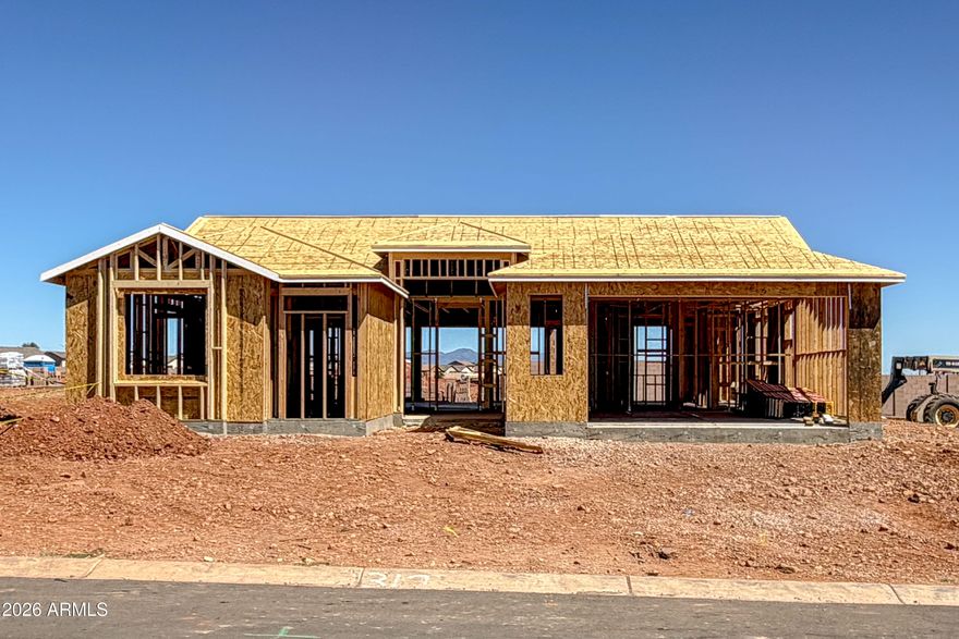 Located in the desirable Buffalo Soldier Ranch community, this 3-bedroom, 2-bathroom home w/ 2.5 car garage features 9' flat ceilings and a bright open layout. Expansive windows bring in natural light, with ceramic tile in main areas and carpet in bedrooms. Kitchen offers quartz countertops, stainless steel appliances, island, and eat-in dining. Ceiling fan pre-wires in living room and all bedrooms. Primary suite includes a walk-in tile shower, no tub, with executive-height quartz counters. Block wall rear yard provides added privacy, with a covered patio for outdoor living. HERS Rated & Environments for Living Guaranteed