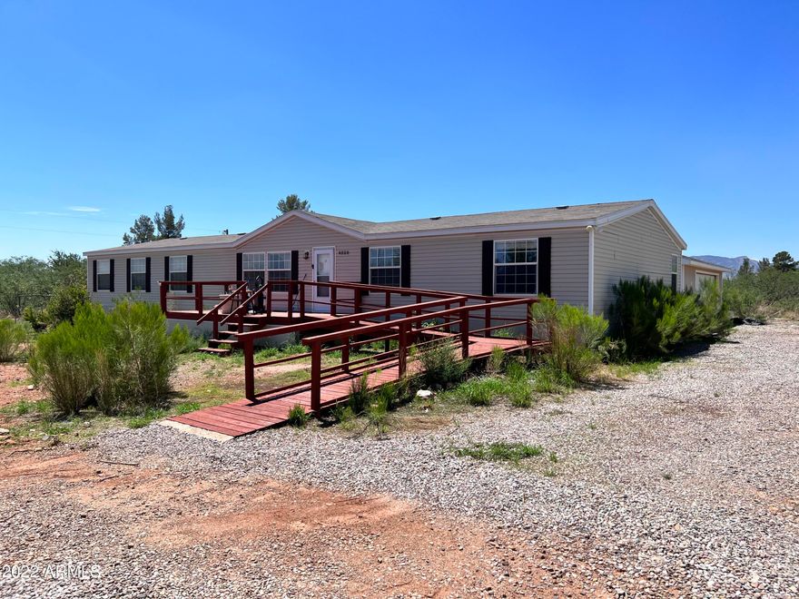This home has a TON of potential!  4 bedroom, 2 bath split floorplan is perfect for a growing family.  Large living room and family room, all electric kitchen has plenty of counter-space and cabinets. Master bedroom is huge, with additional sitting area.  Full master bath with garden tub and separate shower.  Washer and dryer remain without warranties in the house.  Ramps at the front and back entry.  Large covered deck to enjoy the beautiful views of the Huachuca's   On almost an acre of  land, the enormous detached 2.5 car garage makes it perfect for cars and a work shop.  Pumcrete skirting has been installed around the entire home.
This home is being sold ''as-is'', so come take a look and make an offer!