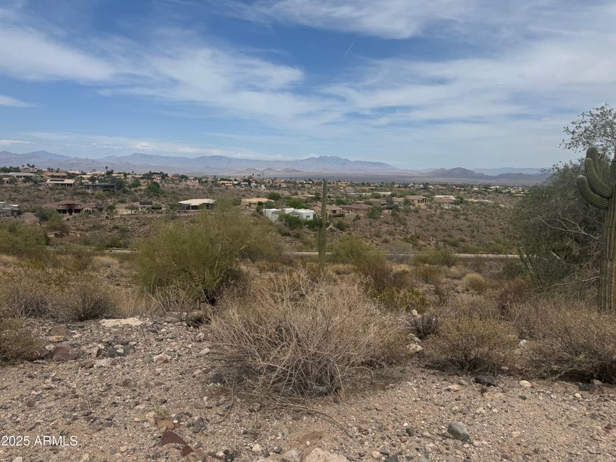 Sweeping panoramic views define this incredible hillside lot in Fountain Hills. Perched above a natural wash, this 1.9-acre property offers a truly special opportunity to build your dream home surrounded by endless mountain vistas and sparkling city lights. A setting like this feels straight out of a movie—peaceful, private, and picture-perfect. Come walk the lot to fully experience the beauty and potential of this unique homesite.