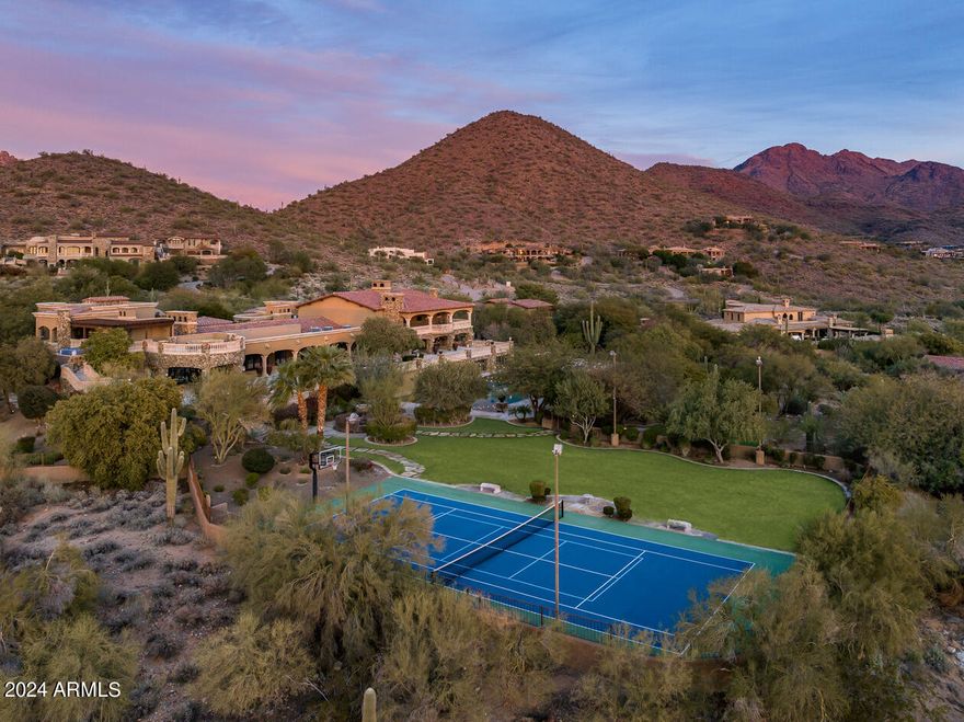 PRICE REDUCED $1M!!! Enter a long private drive to this 7 ACRE +/- compound in exclusive Gated Canyon Heights. Situated on a flat parcel w/spectacular Mountain + City Light views, the 20,088 sf, 9 bedrm compound features 2 HOMES w /2 swimming pools, one an OLYMPIC SIZED DIVING POOL w/high + low diving boards, a tennis court, racquetball court, wellness center, putting green, gym and large grass areas. The main house has 6 ensuite bedrms w/spacious living areas, game rm, den, bar, wine rm + movie theater. The separate guest house can function as 2 private apartments on separate floors each w/private kitchens, living areas & patios. The grounds have multiple patios, fireplaces, fountains, walking paths + childrens play areas.