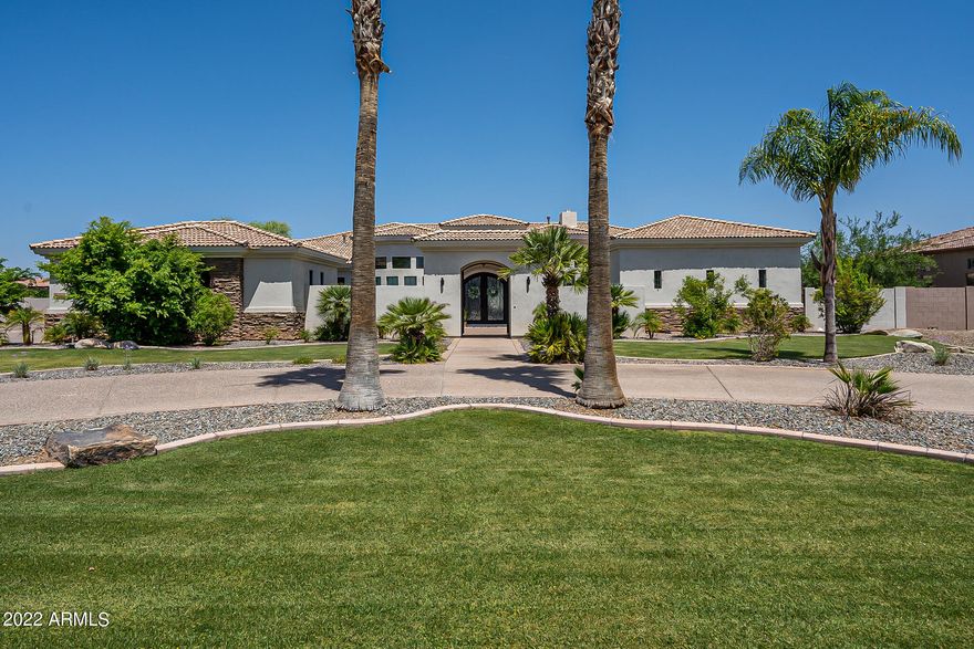 Completely remodeled (2021) 5300 sf custom home in gated Weston Ranch near the Gilbert Regional Park on more than 3/4 acre lot.
You're greeted with a huge private courtyard entry with iron gate. Inside, the light and bright open floor plan is complete with 4 bedrooms plus an office and theater-game room or den. Kitchen and bathrooms were stripped to the studs and re-done with high-end designer finishes. The brand new large kitchen features extensive cabinetry,  GE cafe series appliances including induction cooktop, quartz countertops,  beverage center, and butler's pantry. A large master suite wows with a luxurious free-standing tub, dual entry shower, and his/hers sinks and closets. The remaining bedrooms/bathrooms on the opposite side of the home, maximizing privacy and comfort An oversized 4-car garage completes the checklist of must-haves providing extra space for storage. 

The brand new,easy to maintain back yard (dirt to resort-style in 2020) impresses with an incredible entertainer's dream rec space.
A large 50' x 20' pebble-tec pool with built-in spa, baja shelf and 20' long jumping wall is beautifully surrounded with diamond patterned pavers and turf.  A huge sport court features TWO standard sized pickleball courts and half-court basketball.   
The extended covered patios allow for large groups in multiple  gathering spaces including one with a gas fireplace. 
The owners suite is complete with its own patio with free-standing hot tub and pergola.