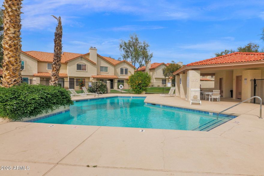 Price revision by $10,000! Nicely maintained two bedroom townhome, ready for your personal touch. Vaulted ceilings and neutral finishes create a bright, open feel with a spacious layout and ample storage. Enjoy a covered patio with adjacent parking for added convenience. Located in a well-kept community with resort style pool, lush mature trees & grass common areas maintained by the association.  This North East Mesa Community of Alta Mesa is close to shopping, dining, year round golf, and A-rated schools. Move-in ready for effortless lock-and-leave living.