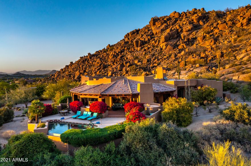 Panoramic Valley Views! Enjoy stunning sunsets, sprawling city lights, and vast mountain views, perched on this breathtaking 2.4-acre hillside lot. Privacy and tranquil living, tucked behind the guard gates of Windy Walk in the legendary, luxury golf community of Troon. A Lee Hutchison design, providing the utmost luxury lifestyle. Boasting soaring ceilings, opening window-wall system creating seamless indoor/outdoor living, allowing relaxed enjoyment, as well as high volume entertaining. Bright and inviting with views at every turn, combined with the extensive use of glass, cantera stone, wood beams, and raku-fired brick set the canvas for this magnificent home. Several view patios, from intimate fireside seating with dramatic cacti and mountain views