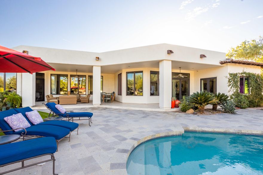 Located on a peaceful street in the heart of Paradise Valley, this sprawling Santa Barbara inspired estate boasts 5 bedrooms, 5.5 bathrooms, formal office with built-ins, workout/bonus room and 4 car garage. Timeless architecture with beautiful finishes, wood stone flooring, tall ceilings and plenty of natural light. The front courtyard features a gas fireplace making it a perfect tranquil entertaining space with Mummy Mountain views. Grand living space and a split floor plan. Open concept kitchen, conveniently located off of the family room and wet bar, features an eat-in island, Sub-Zero and Wolf appliances and  walk-in pantry. Generous sized master suite with wood floors, cozy fireplace, 2 massive walk-in closets, and stunning master bathroom. Beautiful backyard with sparkling pool, jacuzzi, outdoor kitchen, lush green grass areas and plenty of covered patio space. Hurry, before your dream home is gone!