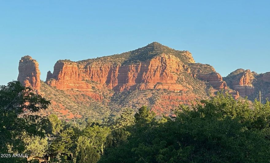 Stunning Sedona retreat with Iconic Red Rock Views. Ideal for Living or Investment. Experience the perfect blend of luxury, comfort, and opportunity in this beautiful 2-bedroom, 2-bathroom townhome with a den that could also be used as the third bedroom. Nestled in a gated country club community at the end of a quiet cul-de-sac, this exceptional end unit is perfectly positioned to capture some of the most breathtaking panoramic views in Sedona of the most famous red rock formations in the town. Relax by the river rock fireplace or on your private deck watching sunsets. The primary suite includes a peaceful covered patio with mesa views. Enjoy a spacious kitchen with stainless appliances, stylish updates and ample storage. Experience unlimited golf in the community too included in your HOA