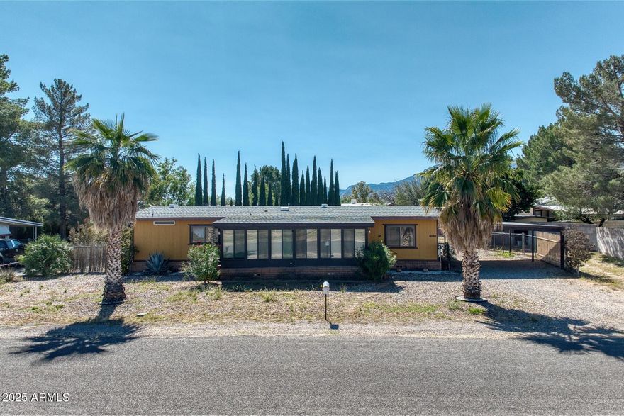 Move-in ready 3 bedroom, 2.5 bathroom home featuring fresh interior paint and brand-new flooring throughout. A fully enclosed Arizona room of 400 Sq ft that connects to a separate craft/hobby/bed room of 320 sq ft with its own window A/C, offering great space for projects or relaxation. Property includes both a 2-car garage and a covered 2-car carport, plus a large attached workshop—perfect for extra storage or work space. Central A/C keeps the home comfortable year-round. Don't miss this unique home with flexible living and bonus space! Check out the hydroponic greenhouse in the backyard where you can grow all of your own fruit and veggies!