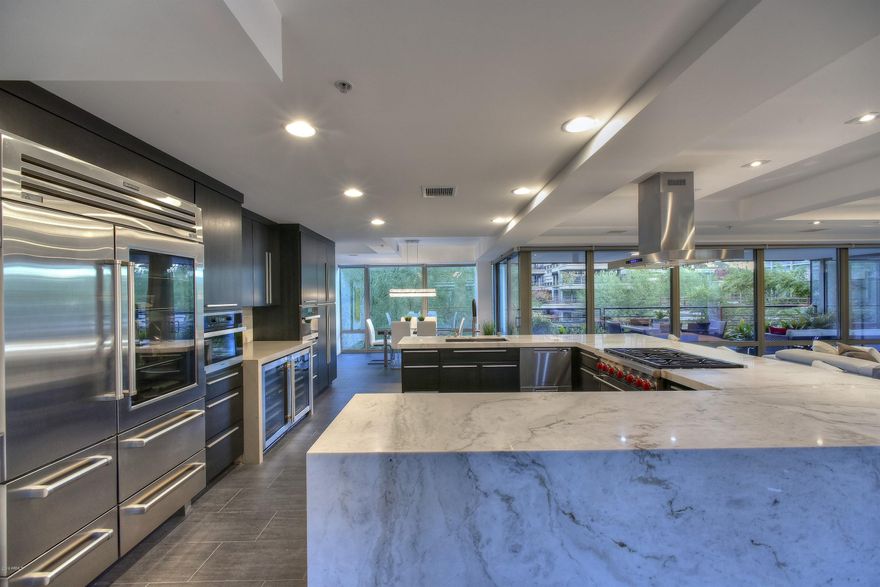 EXTREMELY RARE 4,835 SQFT 5 BEDROOM, 4.5 BATHROOM, BEAUTIFULLY REMODELED CONTEMPORARY CONDO, WITH LARGE BALCONY, FLOOR-TO-CEILING GLASS ON BOTH SIDES, AND GREAT VIEWS OVERLOOKING THE POOL!  Remodeled and decorated, this exceptional bridge condo offers fantastic pool views, an open floor plan, and superior finishes. Features include a gourmet kitchen, marble counter tops, tile and wood floors, and gallery-type walls for displaying art. Amenities include a state-of-the-art fitness center, indoor and outdoor heated pools and spas, basketball and racquetball courts, and men's and women's locker rooms with steam rooms. Concierge service is available, and the Scottsdale Fashion Square Mall, Old Town Scottsdale, restaurants, theaters, and much more are all within walking distance.