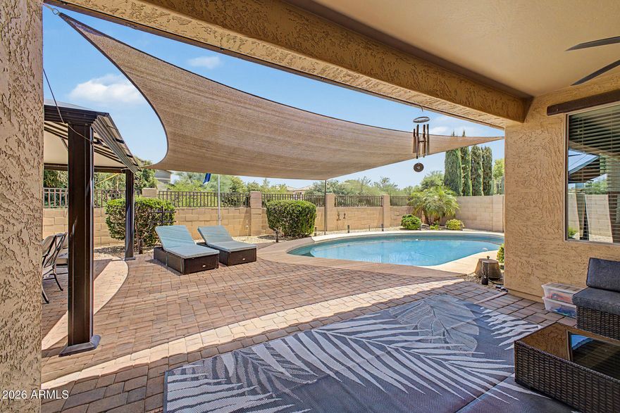 Home, sweet home! Discover refined living in this beautifully appointed 3-bedroom residence with a resort-style POOL, OWNED SOLAR, and timeless curb appeal. A stone-accented exterior, manicured landscaping, and a 3-car garage with CUSTOM cabinetry set the tone for a home defined by pride of ownership and design. Inside, enjoy tile flooring, crown molding, arched details, abundant NATURAL LIGHT and a thoughtful floorplan. The chef's kitchen features staggered cabinetry, granite countertops, stainless steel appliances, a walk-in pantry, and an OVERSIZED island with breakfast bar seating. The spacious primary retreat offers dual vanities, a soaking tub, and separate shower, while a versatile bonus room creates the ideal office or flex space. Exceptional comfort and style await! The backyard oasis is an entertainer's delight, complete with a covered patio ideal for relaxation, a gazebo perfect for gatherings, plenty of seating space with pavers, and a sparkling pool to enjoy sunny days! You don't want to miss it!