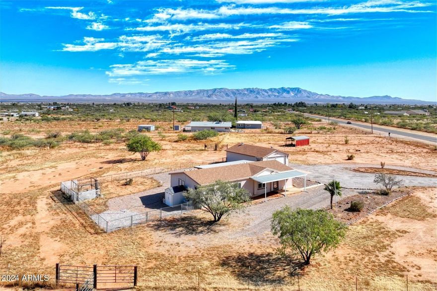 Charming 3-bed, 2-bath manufactured home on 4+ fully fenced acres with stunning views! This property boasts an electric gate with opener, perfect for privacy and security, fully fenced with electric and is ideal for horses. Inside, enjoy a split floor plan, a screened porch, and a gorgeous chef's kitchen with granite countertops and newer appliances. The oversized 24x36 garage includes an RV hookup, offering plenty of space for vehicles and storage. The home also features a newer roof, ensuring low-maintenance living. Conveniently located just off a paved road, this property combines peaceful rural living with easy access to nearby amenities. Don't miss this fantastic opportunity!