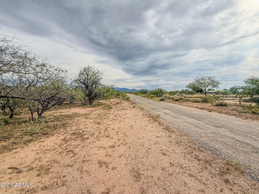 Discover 5+ acres of wide-open space just west of Benson, offering the perfect blend of rural tranquility and convenience. This level, usable parcel provides plenty of room for your dream home, horses, or hobby ranch—with beautiful 360-degree mountain views and stunning Arizona sunsets. Located just off Tequila Trail, the property offers easy access to I-10 for a quick drive to Benson or Tucson. Power is nearby, and there is abundant space for a private well and septic system. Experience peaceful country living with the freedom to create your ideal desert retreat!
The property is a 5.8-acre portion of 12406005B—survey to be recorded at closing.