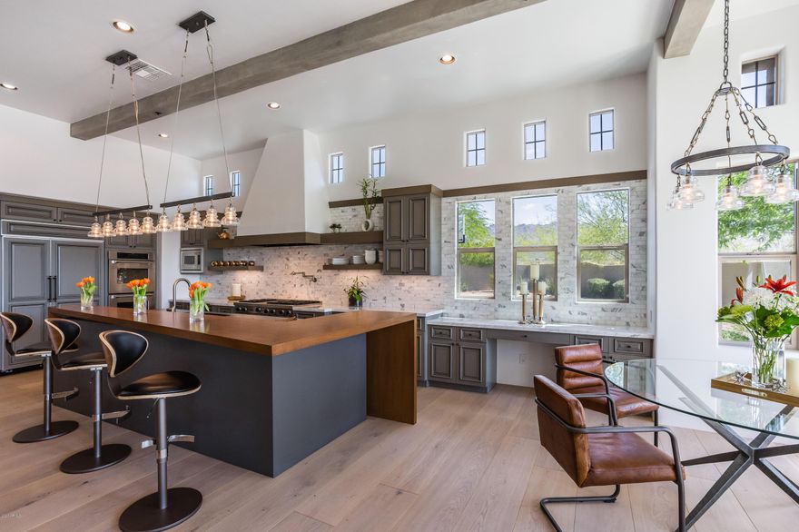 The Ultimate Family Compound in DC Ranch. Rare chance to live in tranquility & scenic beauty! This estate rests at the end of a private culdesac, 3/4 acre lot, 4 car garage w/endless views of the McDowell Mtns & Southern city views both day & night! Professionally redesigned w/ 12'' wide oak white plank flooring, dual folding 18' x 10' sliding doors, modern/open kitchen. Resort style living with multiple interior and exterior entertaining areas for the whole family to enjoy. Features  include modern/open floor plan, with a true seperate guest house w/ 2 seperate bedrooms, kitchen, game room, laundry room and 2 full bathrooms . This home boasts modern elegance w/ seperate master retreat, sitting rm, flex area & private court yard w/ fireplace/ Truly the crown jewel of this community!