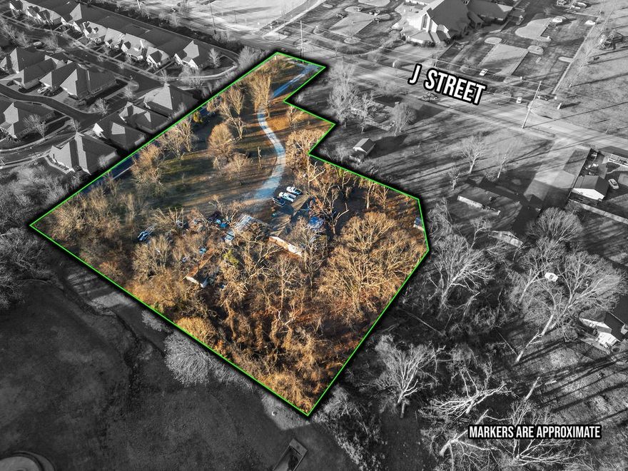 Unparalleled Development Opportunity in the middle of Bentonville’s Museum District.  This 2.37 acres has 55’ of road frontage and is one of the last privately owned parcels in close proximity to Alice Waltons School of Medicine on NE J Street.  Perfect location for mixed use, multifamily, hotel, etc.  Easy access to the new Walmart Campus, Razorback Greenway, Crystal Bridges, and Memorial Park.  Currently zoned Residential, this wooded level lot borders high density zoning, and future multi-use. Buyer to verify utility access.  Home and structures are sold as-is.