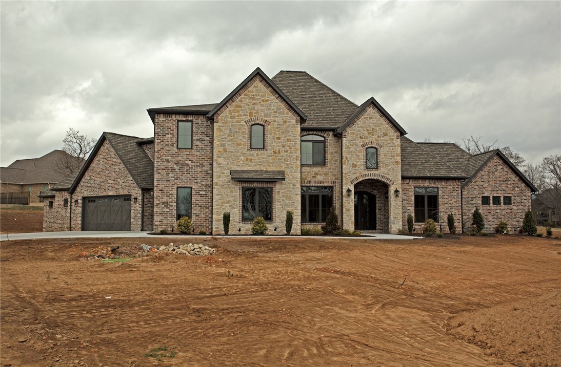 Payne Construction masterpiece... Estate home on over 3 acres, 4 car garage, large bedrooms with walk-in closets, bonus room and fully equipped media room w/ built in wet bar. Second master suite on main level w/own bath and garage access. All the features you want including media room, home audio, central vac, Jenn Air appliances w/a 6 burner cooktop w/griddle and double ovens. Covered back patio w/ built in grill. Huge backyard with mature trees. Highly sought after neighborhood, 1 mile from Elem & Bentonville West High school.