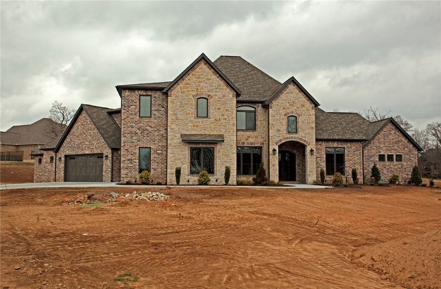 Payne Construction masterpiece... Estate home on over 3 acres, 4 car garage, large bedrooms with walk-in closets, bonus room and fully equipped media room w/ built in wet bar. Second master suite on main level w/own bath and garage access. All the features you want including media room, home audio, central vac, Jenn Air appliances w/a 6 burner cooktop w/griddle and double ovens. Covered back patio w/  built in grill. Huge backyard with mature trees. Highly sought after neighborhood, 1 mile from Elem & Bentonville West High school.