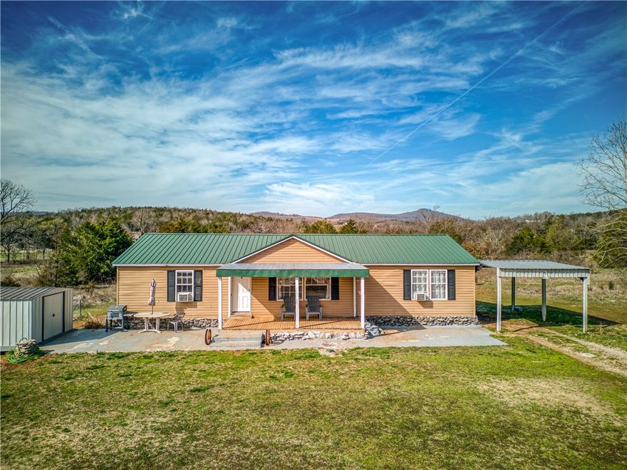 Don’t miss this rare opportunity to own a versatile property close to the beautiful Buffalo River. Situated on 9 level acres, this small farm includes a 3bd, 2ba main home & a 1bd, 1ba guest house (needs a shower) to make it ideal for use as an Airbnb, rental, or private guest space. The main home has cathedral ceilings, pine wood walls, kitchen pantry, walk-in closets, and a split floor plan. Outside, you’ll find multiple buildings, including a 30x50 shop w/3 bay doors (guest house is in one end & has its own septic), blacksmith shop, small storage building & a chicken coop, providing ample space for hobbies, tools, or equipment. Enjoy the peaceful setting, open acreage, and endless possibilities this offers—perfect for anyone looking to blend country living with income potential. Small pond is dry now but could be active again. All this on a paved road! (Pictures are from previous listing.)