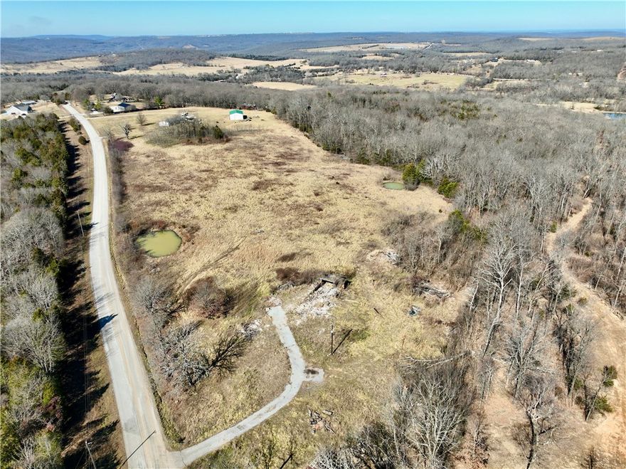 Spectacular buildable tract located minutes from Devil’s Den State Park and a short drive to Strickler, AR. This beautiful property features paved road frontage, electric on site, and rural water along the road. Enjoy breathtaking panoramic views, open pasture, large hardwood timber, and two ponds. Ideal for a dream home, hobby farm, horses, or cattle. Historic features include an old hand-dug rock well and stone fencing remnants. Excellent rural home site and investment opportunity.