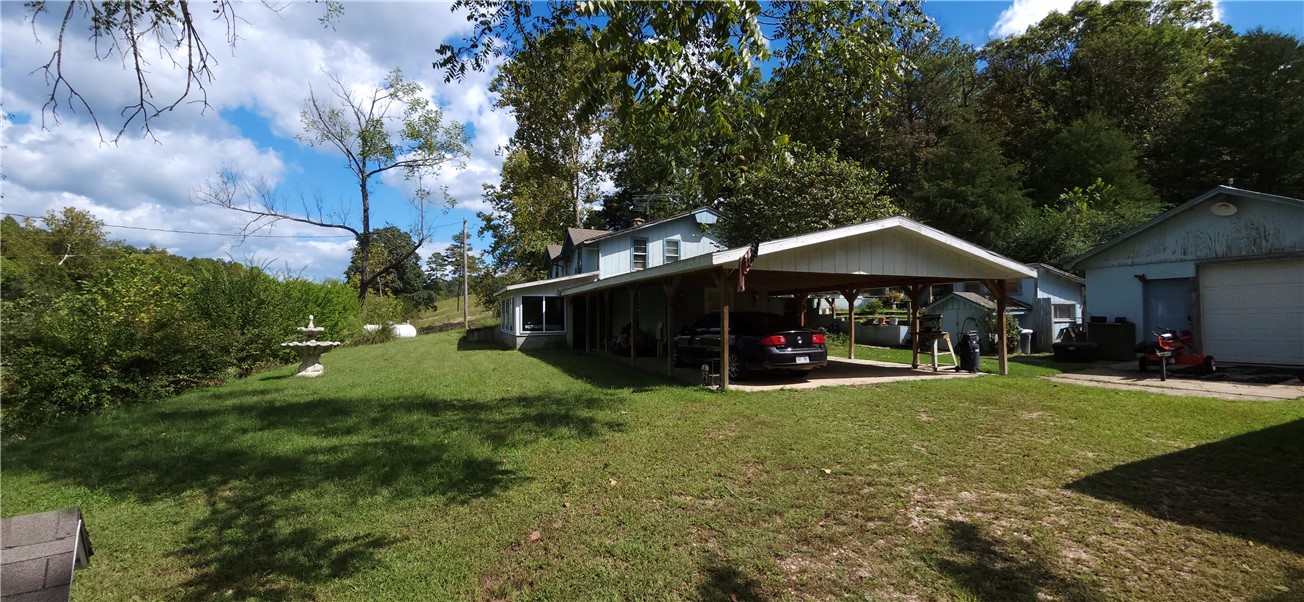 Country living on 2.25 acres with nice 4 bed 4 bath two level home. Native stone fireplace ducted throughout the house, Built in Concrete Storm Shelter. Work shop, green house and water well for all your gardening needs. Two nice sized storage building with Electric and Water. Boat launch 3 blocks from the house. Come add your updates and make this property your home. (Professional Pictures to come)