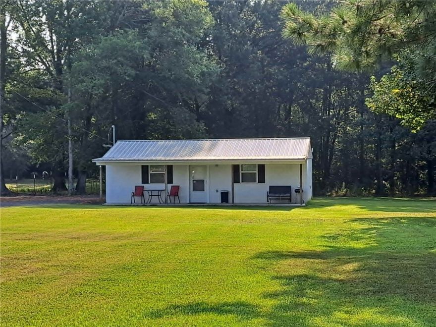 This compact studio-style home on 1.5 acres features an efficient open living space with one full bathroom, making it the perfect low-maintenance retreat or income-producing opportunity. A standout feature of this property is the separate 50-amp RV hookup complete with its own septic system already in place — ideal for additional rental potential, guest accommodations, or a travel trailer setup. With the growing demand for short-term rentals and tiny living spaces, this property is perfectly suited for an Airbnb or dual-income investment opportunity. Enjoy the privacy and charm of country living while still being conveniently located near town. The home may also be purchased fully furnished, making it move-in or rental-ready from day one. It also offers a storage building. Enjoy the privacy and charm of country living while still being conveniently located near town. The home may also be purchased fully furnished, making it move-in or rental-ready from day one. It also offers a storage building.