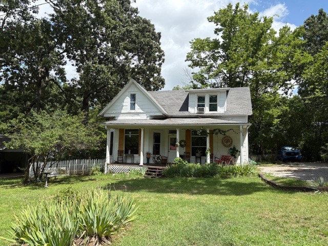 Adorable cottage in the Historic District! Features a main-level bedroom and two additional bedrooms upstairs. The remodeled kitchen includes quartz countertops and stainless steel appliances. Newer interior paint throughout, plus newer windows in the kitchen and dining room. Enjoy the character of original hardwood floors and vintage windows. Relax on the welcoming front porch or back deck—all just minutes from downtown Fayetteville, Dickson Street, the University of Arkansas, and local restaurants!