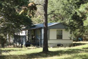 This mobile has plywood floor, no carpet in living room. 14'x70' mobile and bank is getting the title tothe mobile. Covered porch on South side of the home. Wooded land. Bank owned property as is sold as is, where is, with all faults. Title conveys by special warranty deed.