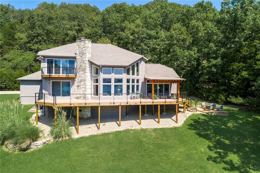 Stunning contemporary design paired with expansive views make this property a standout on Beaver Lake. Clean,open, and light, this home has been completely remodeled with great attention to detail. The open living kitchen and great room are highlighted by a wall of picture windows bringing the outside in. Spacious decks create the indoor/outdoor living that make it truly unique. Secluded on a beautifully landscaped lot the property includes a private 10x24 1 slip dock with swim deck. A must see!!