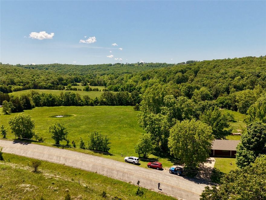 Welcome to your own private farm retreat on 149 beautiful acres m/l, featuring 3 ponds, a year-round creek, open pasture, and mature trees throughout the property. Conveniently located just off Highway 412, this peaceful setting offers the perfect balance of privacy, serene countryside views, and easy access to Huntsville, Springdale or Fayetteville. 
The charming home has a lot of possibilities (as is) offers 1,948 heated square feet plus an additional 858 square foot basement family room, providing plenty of space for storage, hobbies, or expansion possibilities. Inside you’ll find 3 bedrooms, 2.5 bathrooms, and timeless vintage character that adds warmth and personality throughout the home. A covered carport adds convenience and functionality. 
Whether you’re looking for a working farm, family homestead, recreational property, or peaceful country escape, this property offers endless potential with beautiful land and a truly special setting.