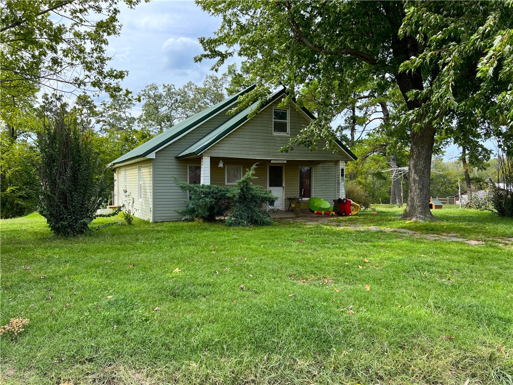 Located in southern Washington County, Arkansas, this 27-acre property at 19909 Antioch Rd, Canehill, AR 72711, offers a blend of nature and history. The property boasts a charming 100-year-old, 1280 sqft home with 2 bedrooms and 1 bathroom, providing a cozy retreat. A detached 2 car garage and a barn sits on the property in close proximity to the home. Some pasture sits on the northwest corner of the property. Additional acreage is available.