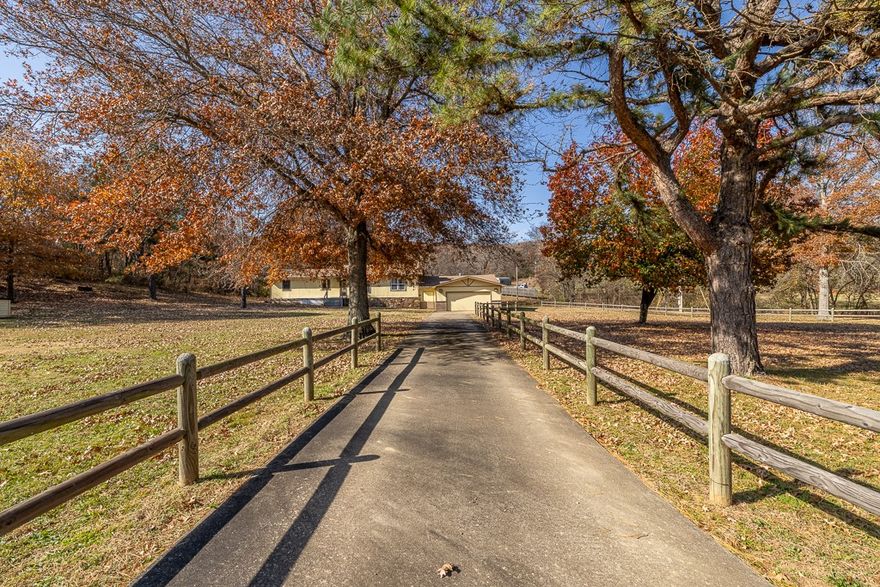 3Br-2Ba house, 50.5 peaceful acres, & a 1200 SF red iron shop! Solid, well-maintained home. 2 living areas & dining area. Newly painted, new carpet, new wood-burning fireplace insert with blower in the main living room, updated kitchen with stainless steel appliances (double oven), remodeled primary bath (new vanity & walk-in shower). Replacement windows - some Anderson windows. Private Cypress wood deck off the primary bedroom. Large covered & enclosed back deck. Newer heat pump & energy-efficient electric radiant heaters for backup heat (along with the fireplace insert). Oversized garage. Newer septic system. The shop has electric (110 & 220 volts). Nice 12/24 storage building. Garden area. A tranquil wet-weather brook runs through the property. Some of the land has been selectively logged/cleared. The house is on rural water & there is a functional well for garden irrigation. Fiber internet is available via Ozark Go. Refrigerator, washer & dryer convey. Can purchase house & 10.5 acres - MLS 1327460.
