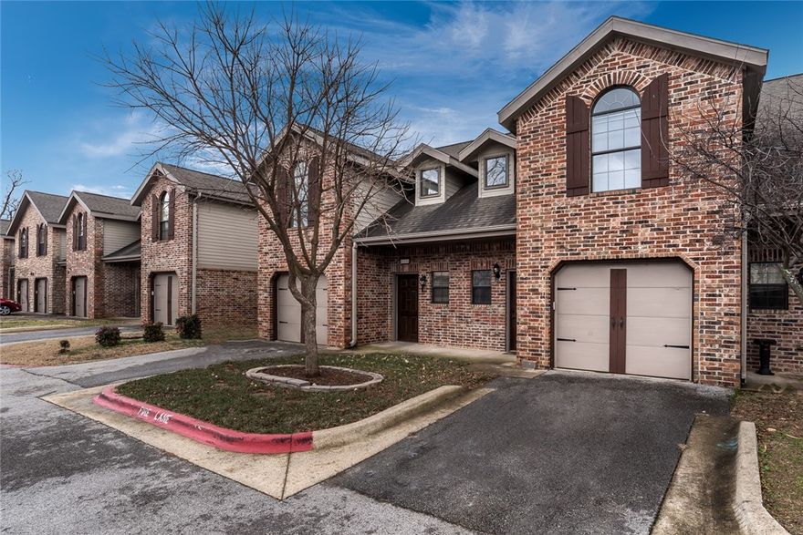 Beautiful European style townhome in excellent location! Centrally located with easy access to I-49 for short travel to all the best NWA has to offer. Close to shopping, dining, and entertainment. Private and quiet community. Townhome features garage parking. This home welcomes you inside with a vaulted entryway and stairway to second story. Entryway leads into the kitchen and dining area that is spacious for entertaining. Pantry adds storage space. Large living room has fireplace and built-in entertainment alcove. Backyard is privacy fenced and has patio for outdoor living space. Upstairs is Master bedroom with walk-in closet and attached bath. Guest bedroom upstairs also has attached bath. This unit is a must see!. All Kitchen appliances, lawn care and trash pick up are included. **This property is currently in the process of being renovated.**