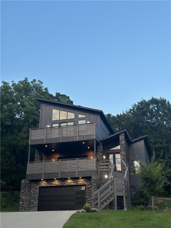 Stunning Hilltop Retreat with Breathtaking Views of Old Main. Perched at the top of a quiet hill near Root Elementary School, this exceptional Fayetteville residence offers panoramic views of Old Main and unforgettable sunsets from two expansive west-facing patios. Backing up to a serene wooded area filled with deer and native wildlife, this home provides unmatched privacy and a true connection to nature, all while being minutes from the heart of town. Thoughtfully designed with comfort and luxury in mind, the home features two spacious primary suites, each with a private bathroom boasting elegant tilework and freestanding soaking tubs. Modern hardwood floors, plentiful windows, and large sliding glass doors flood the home with natural light, while contemporary fixtures and premium KitchenAid stainless appliances add style and convenience.The fully finished walkout basement includes a bonus room and a media space. Walking distance to Lake Lucille!