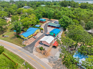 Welcome to your dream lakeside retreat - a fantastic opportunity to own a charming lakeside resort that offers an escape from the everyday hustle and bustle. This picturesque property, consisting of 2- 1-bedroom rooms with kitchenette, 2 sets of adjoining motel-style rooms, a cozy 2-bedroom, 1-bathroom cottage, and a separate honeymoon suite with a kitchenette, is a haven for both nature enthusiasts and vacation seekers. The main building serves as the heart of this charming property and features 2 bedrooms, 1 full bathroom, and 2 half bathrooms for visitors. Whether you're looking for a full-time residence or an onsite management space, this building provides versatile options for your convenience.