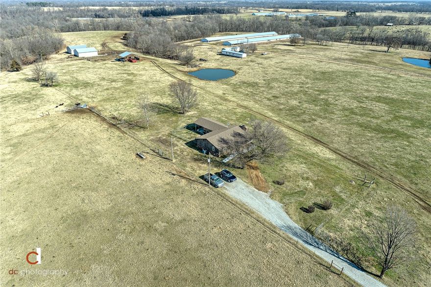 FANTASTIC WORKSHOP, 40’ x 64’ (2013) with concrete floor and propane heat. Find calm in the serene country views and wildlife. 76 acres of verdant pasture, fenced, 2 ponds, 2 draws with 7 acres of timber and a hollow, 6 outbuildings. This 3 bedroom, country style home features a wood burning, rock fireplace with heat vented to each room. Beautiful wood floors, roof, and windows all replaced in 2013.  Spacious bright, sunroom (293’) with covered patio. New Dishwasher.  The HVAC system, replaced in 2008, uses either electric or propane for versatility.  Home Warranty. Enjoy the country life from either your covered front porch or covered rear patio. Grill a thick steak and take in the fresh country air.  See also MLS 1173744 & 1173804.