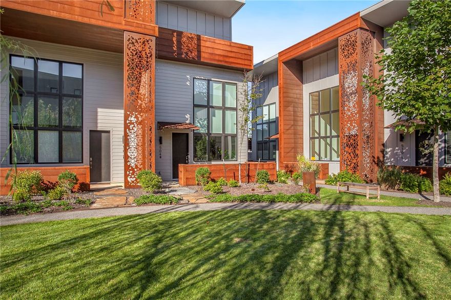 Elevate your lifestyle in this stunning townhome in the desirable Tourmaline Urban Lofts. Located in the heart of Downtown Bentonville's vibrant Market District, the convenience to biking trails, The Momentary, and 8th St Market is unmatched. The contemporary elegance of this residence boasts soaring ceilings and an abundance of windows in the main living area, allowing for ample natural light. A sleek, yet modern kitchen opens to the living room. Retreat to the top-floor balcony, offering a peaceful space overlooking the common area. A private patio with a fence located on the main level is an ideal area for grilling or outdoor entertainment. The exquisite curb appeal of this townhome boasts a beautifully landscaped common area, along with metal features that were hand-crafted through an innovative underwater technique. With 3 bedrooms, 2.5 half baths, and 2 designated parking spots, this residence offers an amazing opportunity to experience the best of Downtown Bentonville living.