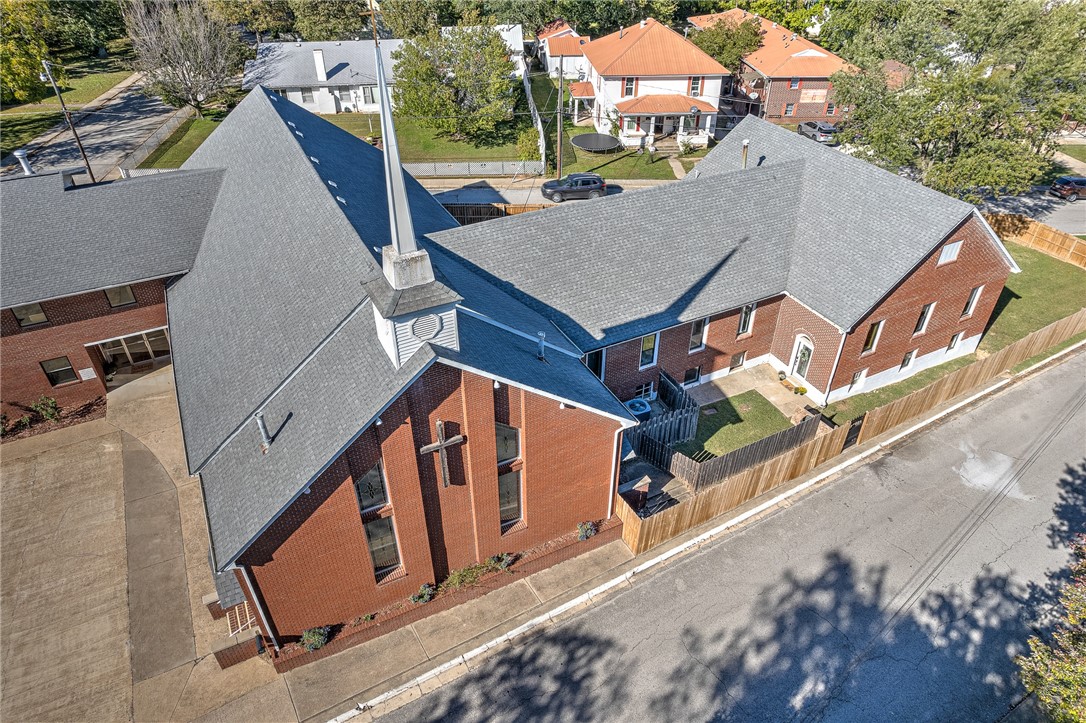 This remarkable property boasts approximately 2,600 sqft for your one of a kind, personal home. The stunning residence includes 3 bedrooms, 2 baths, large open custom kitchen & 2 living spaces, which share a fireplace. Original wood floors & ceiling sparkle in this exceptional & unique space! This conversion was done with pristine attention to detail & high-end finishes. The magnificent sanctuary, with stage, choir balcony, Bride rooms & Baptism tub is ready for your congregation, weddings, or just about anything you can think of doing with this lovely & adorned space. The large & spacious fellowship hall includes, 5 bathrooms & a kitchen. So many large rooms, with an incredible range of uses. Spacious basement is there for you to create your own space; office, gym, or media room, or all of these! Professional pictures coming soon!