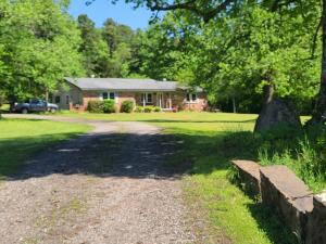 5 acres, view of Chickalah Mountain, covered deck, and 2 shops are bonuses the 3 bedroom 2 bath home in the country offers. 1948 sq ft, granite, and a huge living room in thie home give you plenty of room. There is a nice sized utility room that has doubled as a sewing room. Plenty of room for a gard;en; get the well going for beautiful plants. The covered, chainlink dog kennel will convey with property. Schedule your appointment and check out the view now. There is still time to get a garden planted for summer bounty.