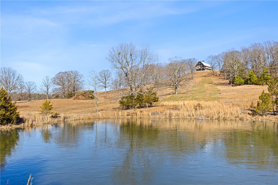 This is a once in a lifetime opportunity! The Snowlick Mountain Ranch includes 317.78 Acres and Panoramic views for miles. With roughly 100 Acres of manicured fields, 4 ponds and the remaining prime hunting ground with napier creek running along the southern border. This tract was previously a high fence ranch with miles of 8 foot fence still remaining. The Brand New Custom built (Timber Frame) Cabin is like something you'll only see from a magazine. Every Log, board and Peg that built this Cabin was harvested from this property, it's so incredible to see the craftsmanship and perfection that went into this build. The Cabin is 5,600 Sqft Heated and Cooled with the garage area included. Upstairs in the main living area is 2,800 Sqft 2 Bedrooms and 3 Full bathrooms. THIS WILL NOT LAST LONG!