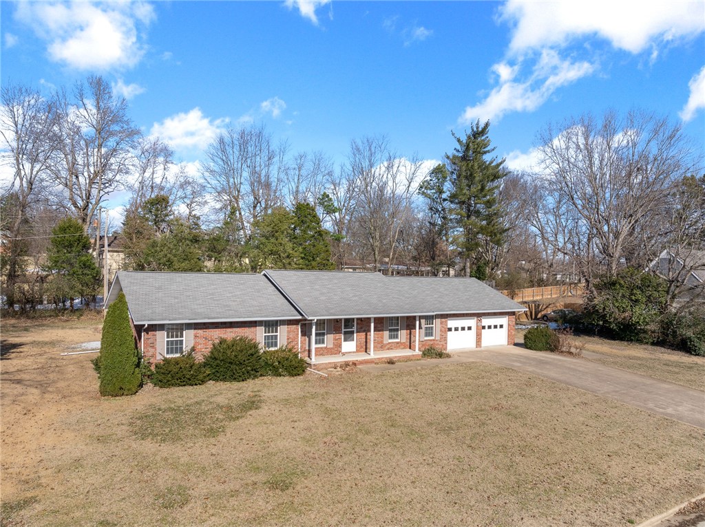 This quality-built home sits on a gorgeous lot in a highly desired neighborhood in Harrison. It includes over 2000 square feet all on 1 level. Featuring a split-floor plan, it has 3 bedrooms and 2 full baths, a beautiful kitchen, a large living room, plus an extra living room or bonus room. The primary bedroom has a huge walk-in closet. The U-shaped kitchen gives you lots of counter space and includes appliances and a pantry. The home features upgraded Pella wood windows throughout and a beautiful gas log fireplace.