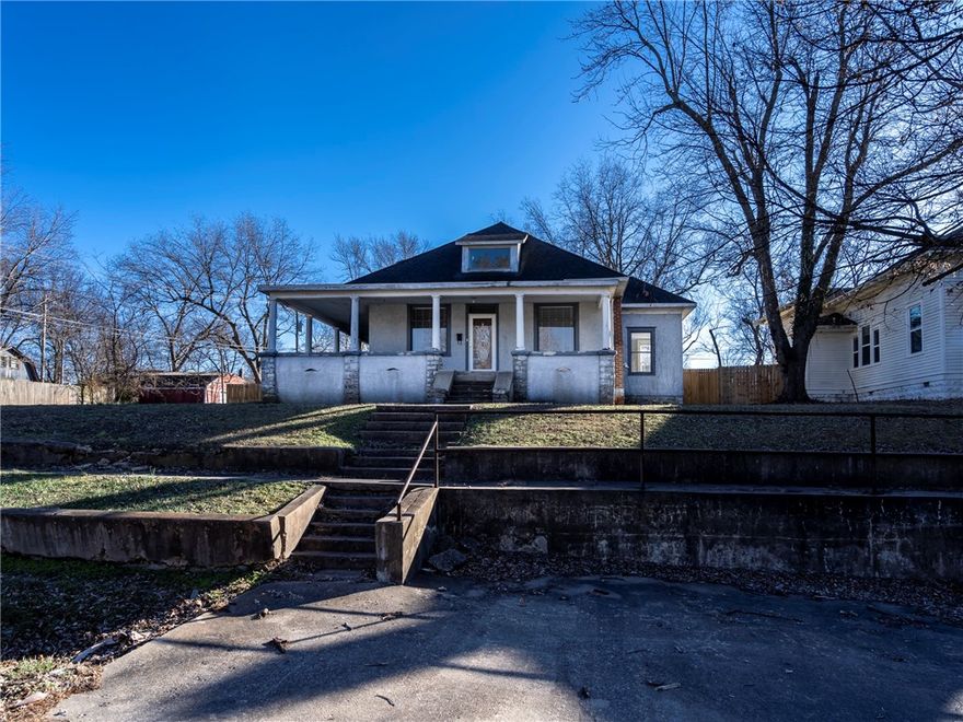 This historic 4 bedroom, 2.5 bath home, circa 1909, is located in Beachamps subdivision, which was established in 1880 and is located on a corner lot close to downtown businesses and dining, the amphitheater and library.  It has two levels and an unfinished cellar, not included in square footage.  The front and side doors are original to the home. There is a vented pellet stove in the living room. Two bedrooms, dining room, kitchen and office/bedroom, side and back porch are on main floor.  Upstairs area includes a second bathroom and bedroom and play area. Main bathroom was renovated in 2023 with walk-in shower and double sinks. Half bath on main floor, additional kitchen cabinets, new hot water heater, gas range and dishwasher were added in 2023. New patio deck and fence in 2023.The central heat and air is dual control. All hardwood floors were refinished in 20223 LVP was added to downstairs bedrooms in 2023. Doorbells on all entrances also added.